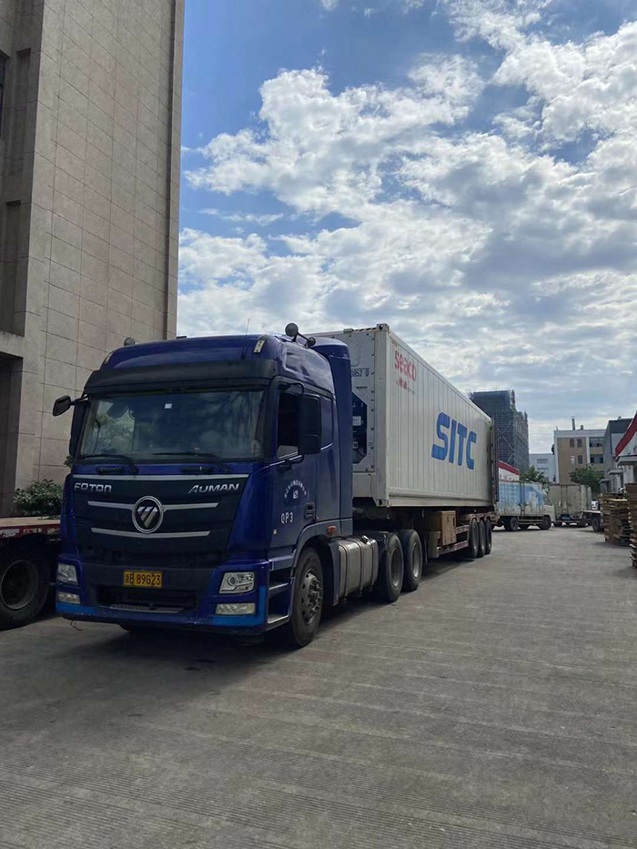 Dedicated Workers Load Two Containers for Export and Two Trucks for Domestic Delivery in Sweltering Heat