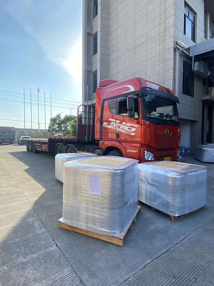 Dedicated Workers Load Two Containers for Export and Two Trucks for Domestic Delivery in Sweltering Heat